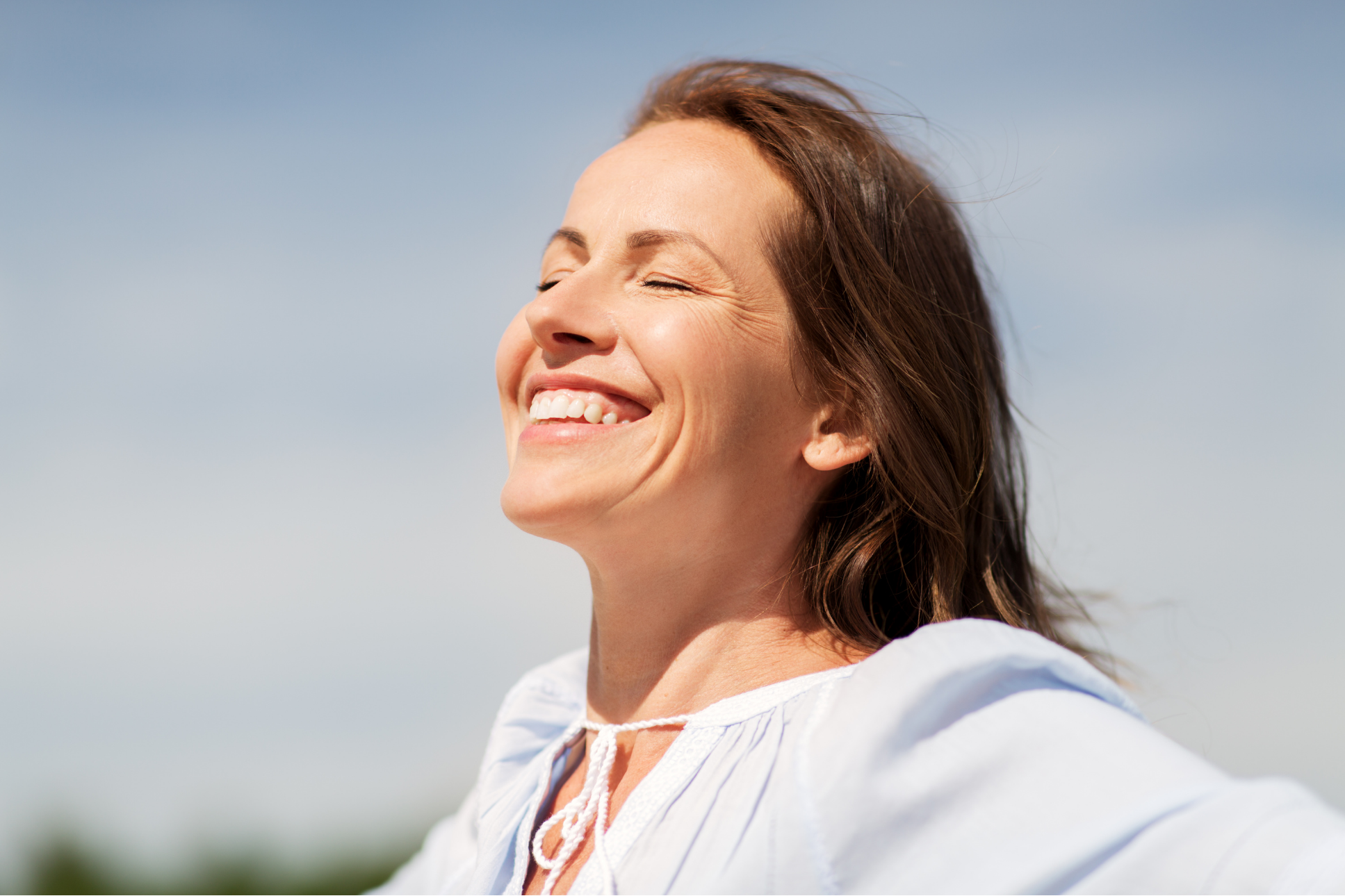 Woman enjoying morning sunlight to support natural vitamin D production and healthy skin in Omaha